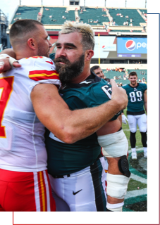 Brothers, Travis Kelce and Jason Kelce hugging post game.