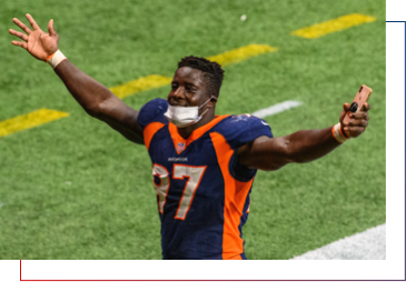 Denver Broncos player with arms wide open